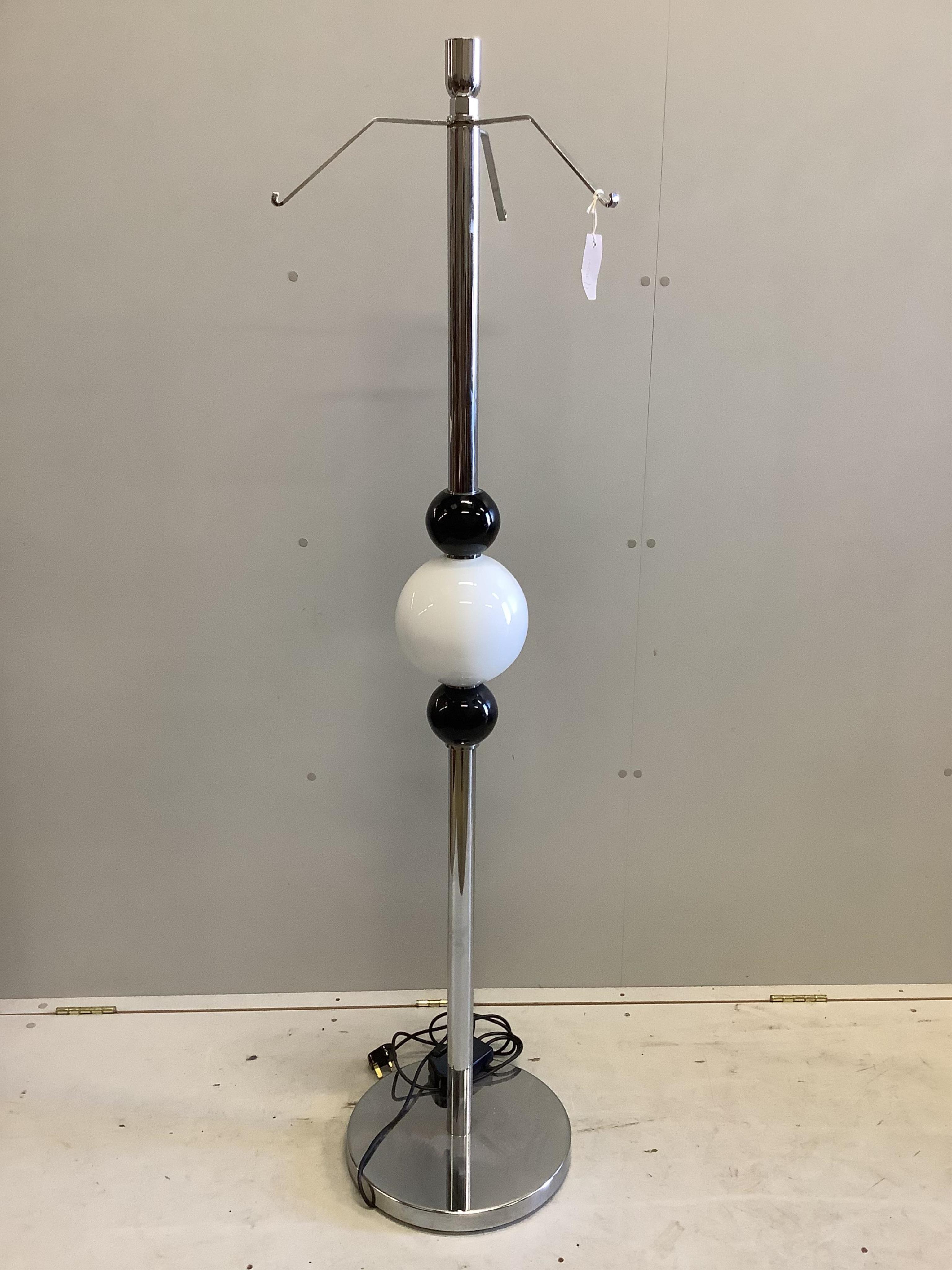 A Contemporary chrome and glass floor lamp, lacking shade, height 160cm. Condition - good